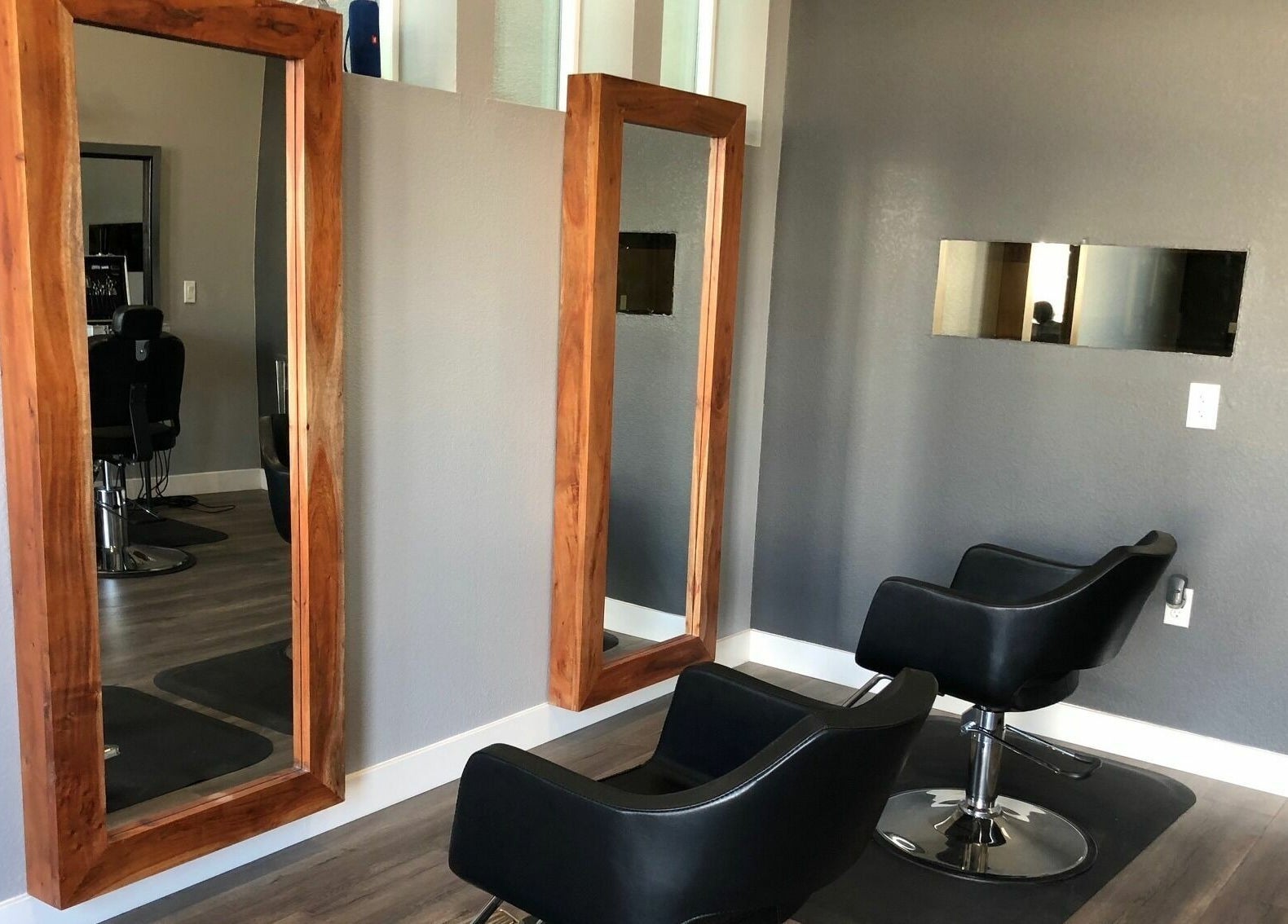 Stylish salon chairs and mirrors at Dappers and Dolls, Milpitas, California, US.