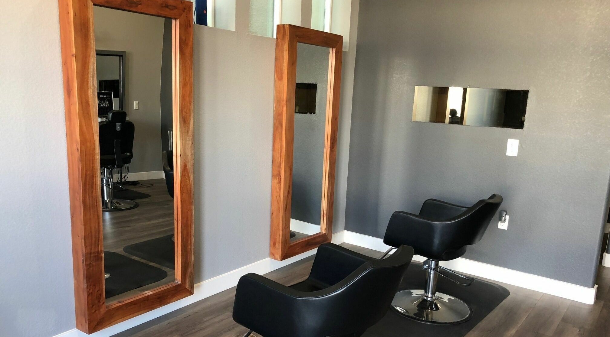 Stylish salon chairs and mirrors at Dappers and Dolls, Milpitas, California, US.