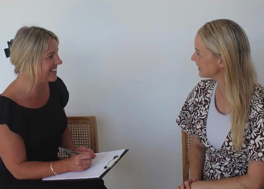 Two women in consultation at Iluka Skin, Maroochydore, Queensland, AU, in a calming white room.