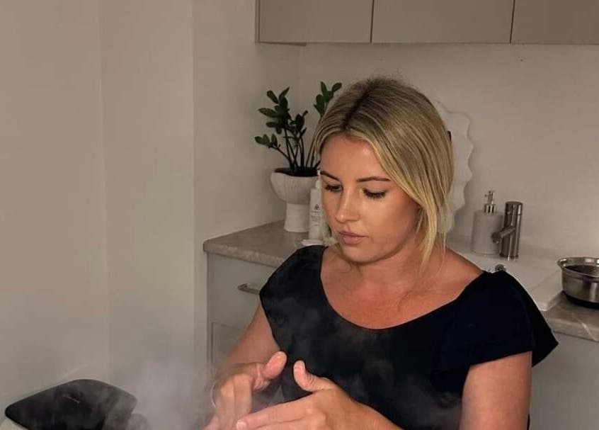 Aesthetician at Iluka Skin in Maroochydore, Queensland applying skincare treatment, focused on relaxation.