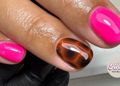 Stylish nail art with hot pink and tiger eye design at CURED BY KHLO, Great Bookham, England, GB.