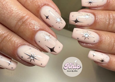 Stunning starry nail art at CURED BY KHLO, Great Bookham, England, GB showcasing intricate designs.