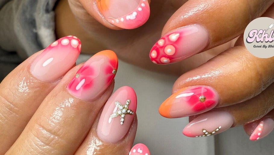 Vibrant nail art design at CURED BY KHLO, Great Bookham, England, GB with orange and pink tones.