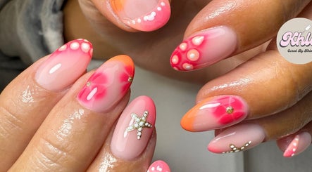 Vibrant nail art design at CURED BY KHLO, Great Bookham, England, GB with orange and pink tones.