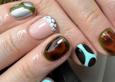 Unique nail art design at CURED BY KHLO in Great Bookham, England, GB showcases colorful and intricate patterns.