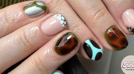 Unique nail art design at CURED BY KHLO in Great Bookham, England, GB showcases colorful and intricate patterns.