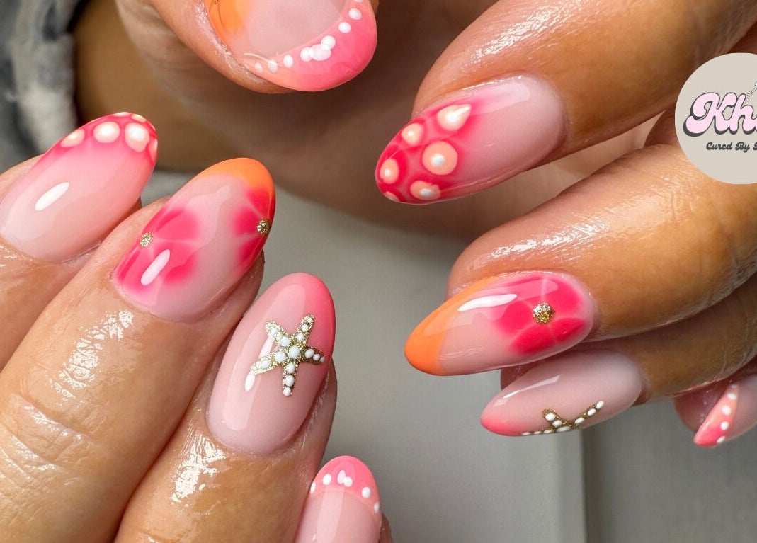 Close-up of vibrant nail art with star designs at CURED BY KHLO, Great Bookham, England, GB.