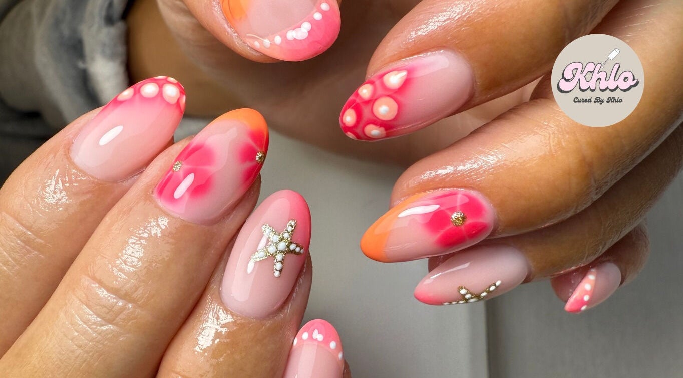 Close-up of vibrant nail art with star designs at CURED BY KHLO, Great Bookham, England, GB.