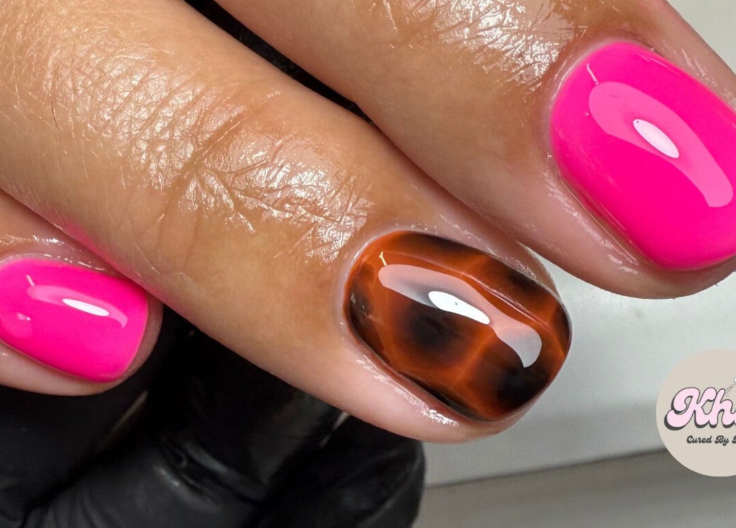 Bright pink and tortoiseshell nails at CURED BY KHLO, Great Bookham, England, GB.