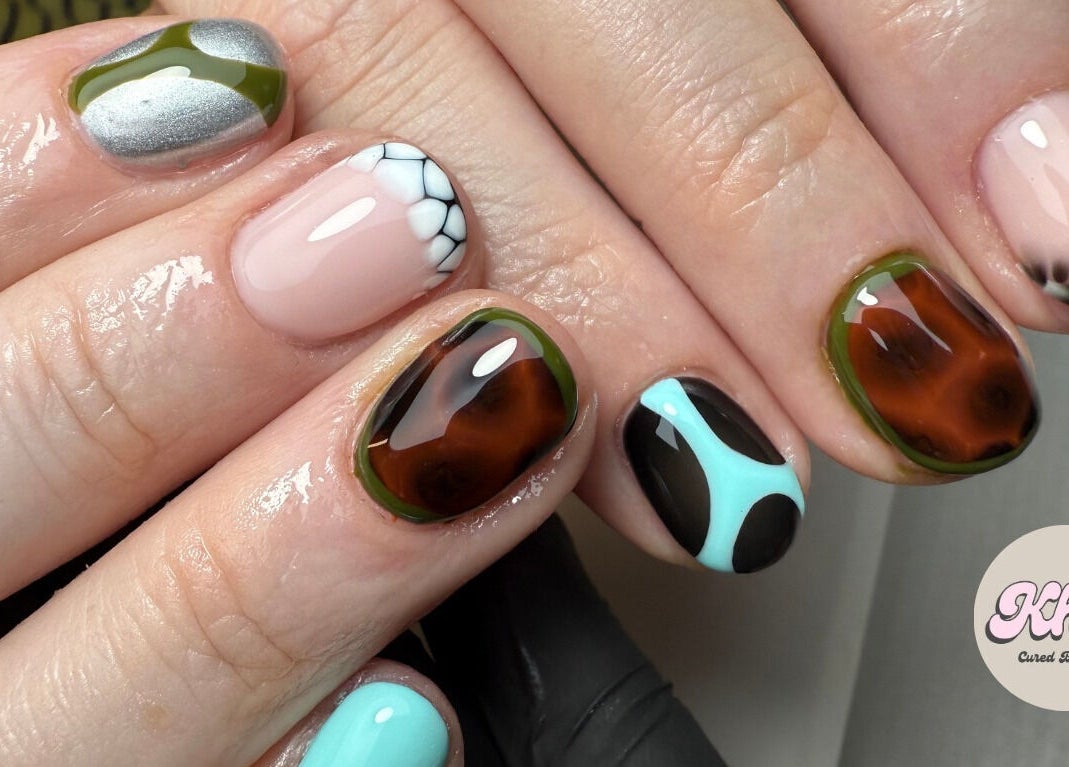 Unique nail art designs at CURED BY KHLO, Great Bookham, England, GB. Featuring diverse, colorful patterns.
