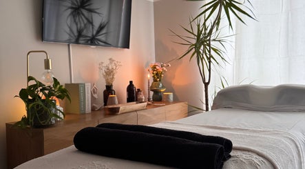 Relaxing therapy room at Gaia Holistics, Clifton Upon Dunsmore, England, GB. A tranquil space with plants and candles.
