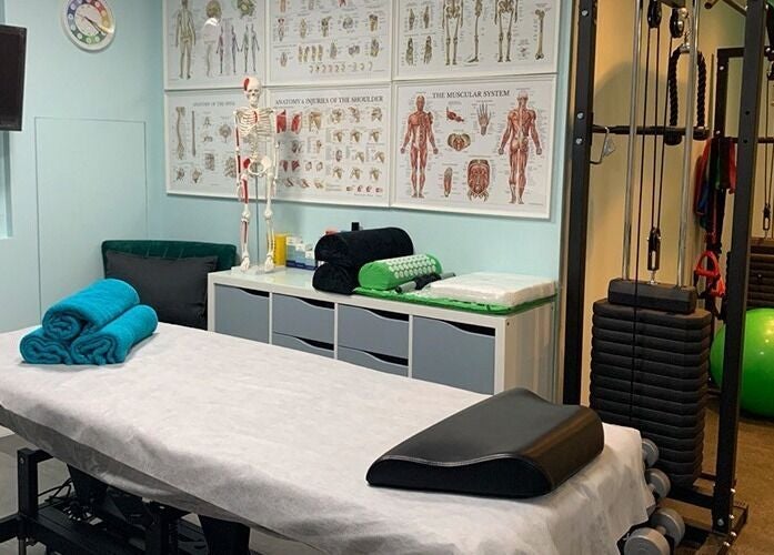 Therapy room at SPINEWELL - Remedial and Sports Massage Therapy in Dunfermline, GB, featuring massage table and equipment.