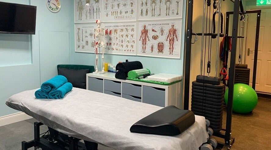 Therapy room at SPINEWELL - Remedial and Sports Massage Therapy in Dunfermline, GB, featuring massage table and equipment.