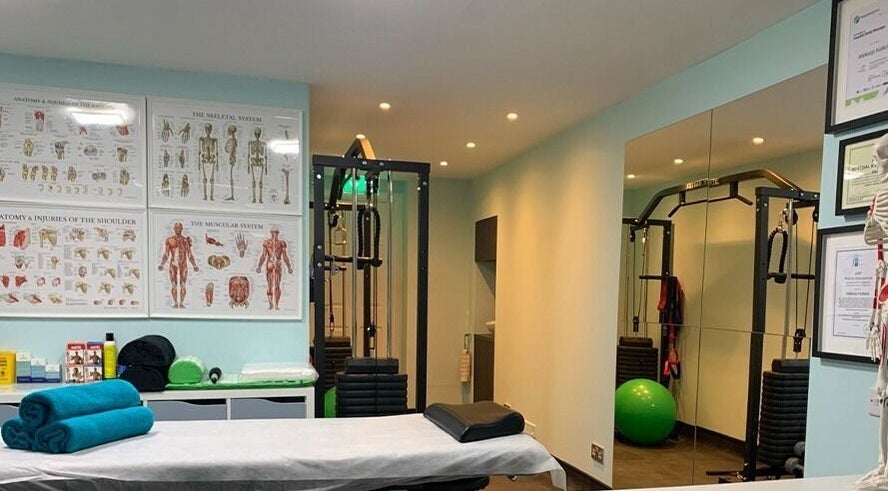 SPINEWELL therapy room with massage table and exercise equipment in Dunfermline, GB.