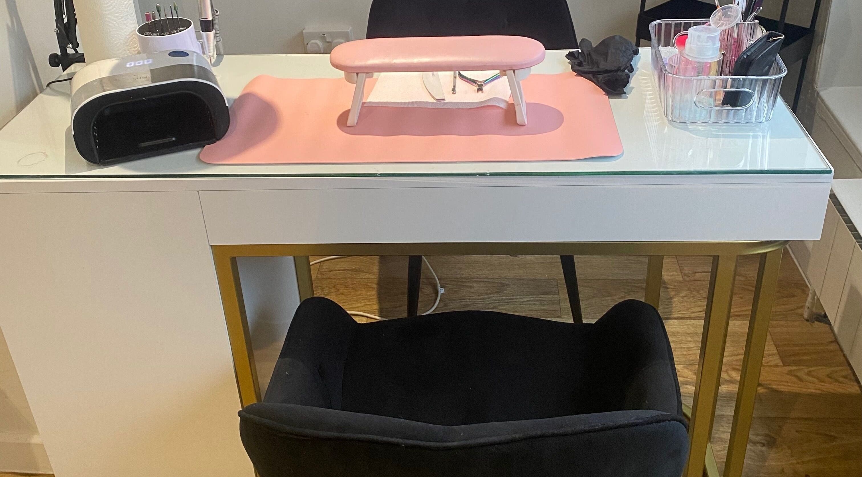 Nl Nails modern nail station setup in Telford, England, GB, with manicure tools and pink mat.