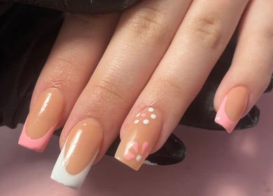 Elegant nail art with pink tips and floral designs at Nl Nails, Telford, England, GB.