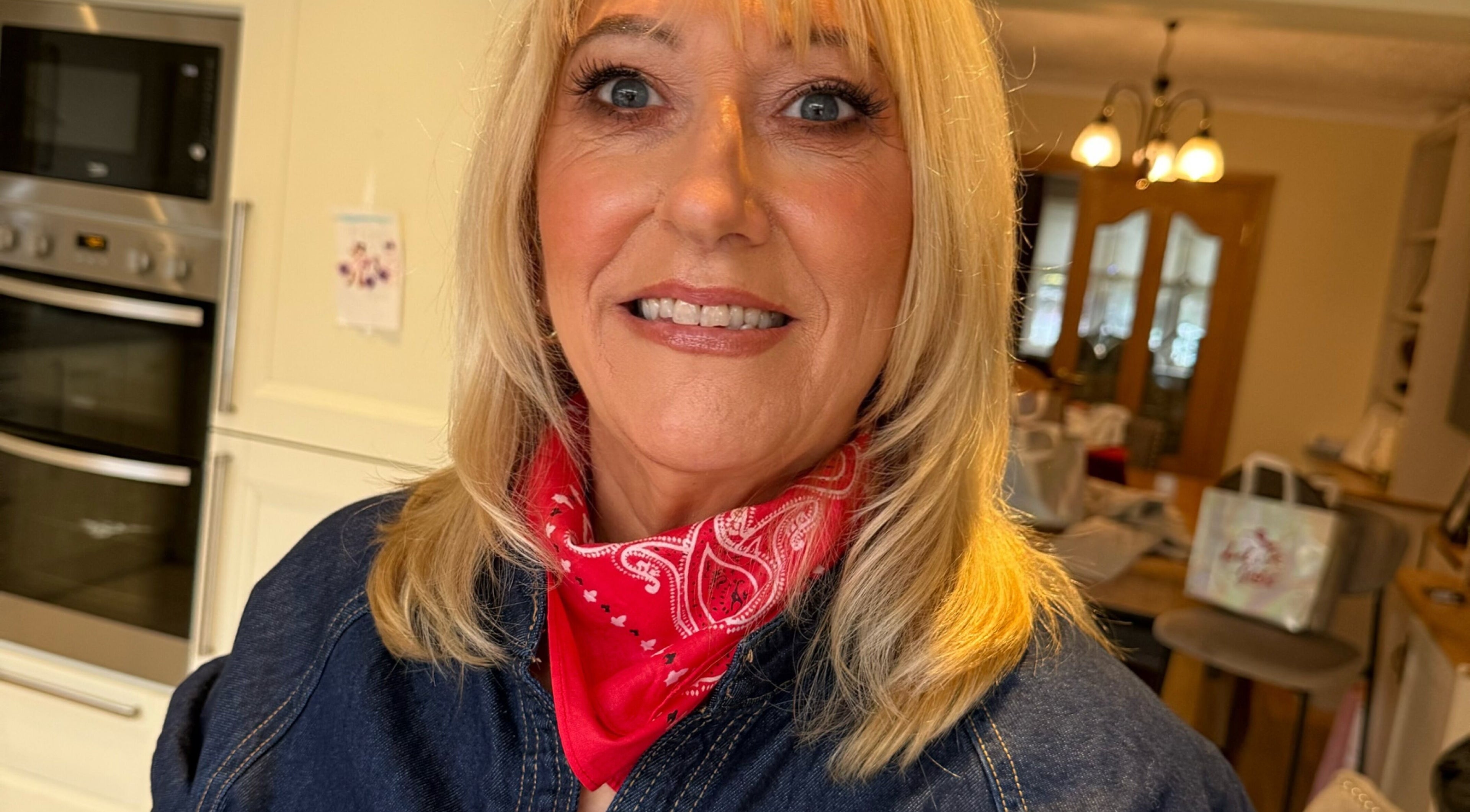 Smiling woman in red scarf at LuminousGlowStudio, Clane, County Kildare, IE, showcasing beauty care.