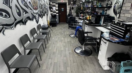 Modern interior of Boss Kutz Barbers in Birmingham, England, GB with chairs, mirrors, and graffiti wall art.