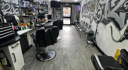 Interior of Boss Kutz Barbers featuring stylish chairs and urban graffiti in Birmingham, England, GB.