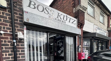 Exterior of Boss Kutz Barbers in Birmingham, England, GB showcasing its modern facade.