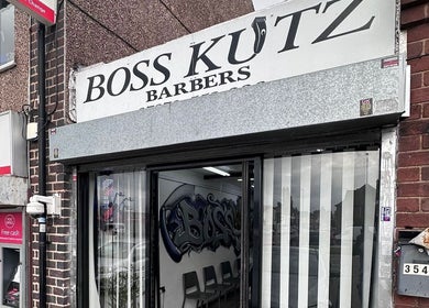 Exterior of Boss Kutz Barbers in Birmingham, England, GB, showing the modern storefront and signage.