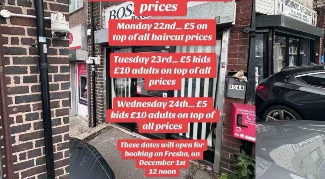 Exterior of Boss Kutz Barbers in Birmingham, England, GB with promotional haircut prices displayed.