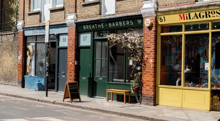 Street view of Breathe Barbers in London, England, GB with charming greenery and classic signage.