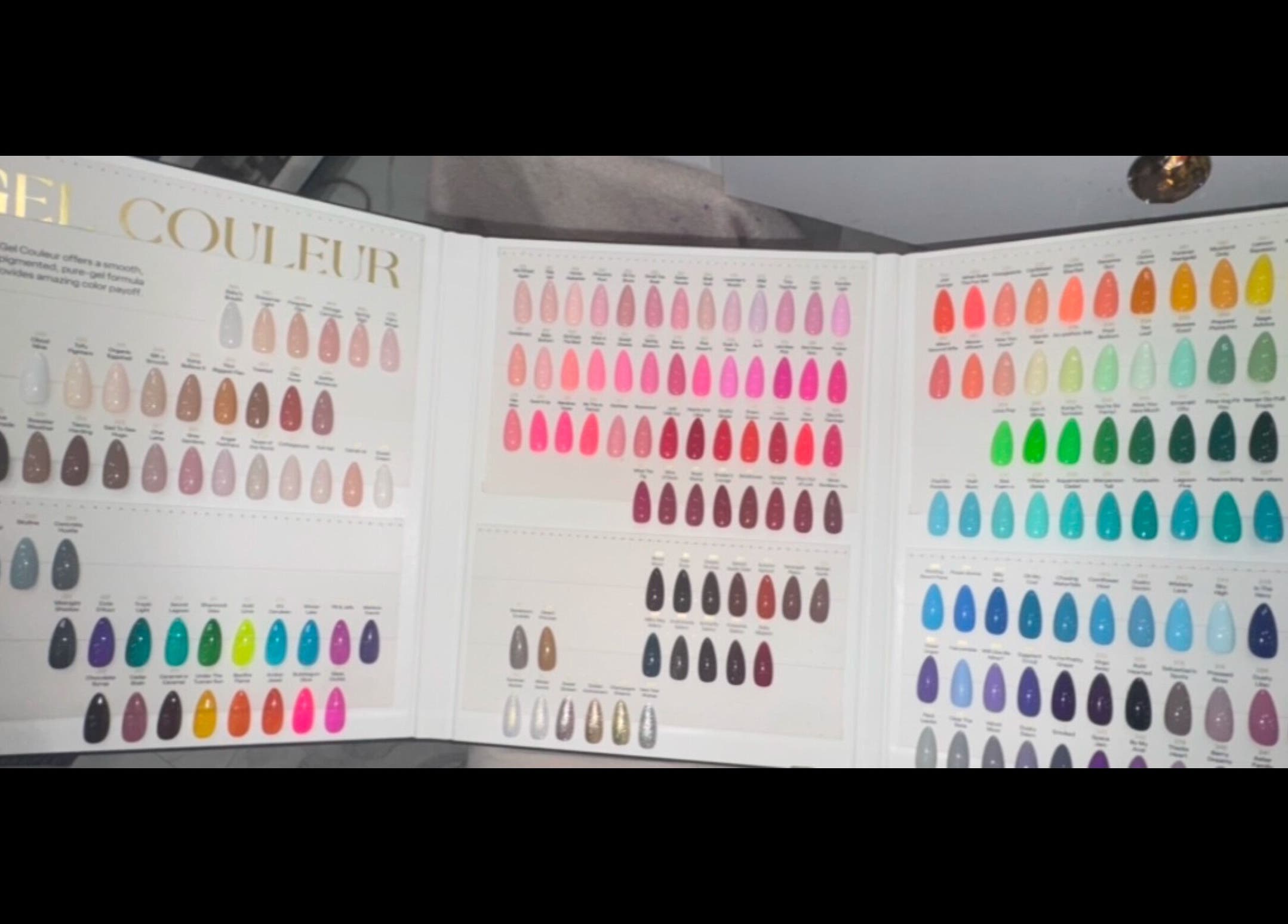 LinSlayed; Happy Nails Spa in Bolivar, Missouri, US, showcasing a vibrant gel nail color chart display.