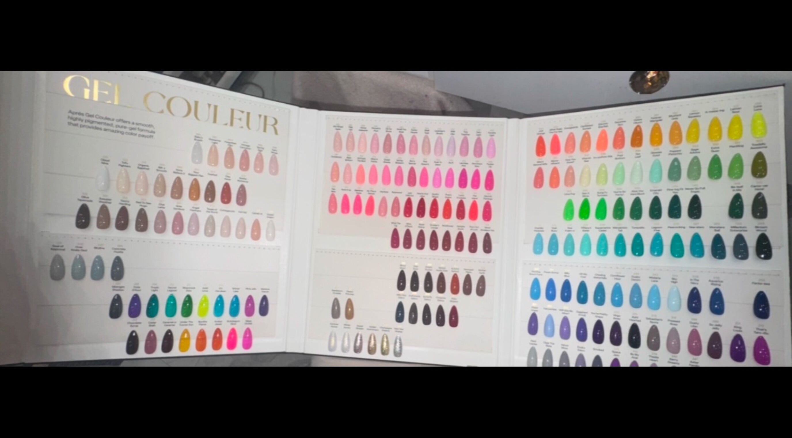 LinSlayed; Happy Nails Spa in Bolivar, Missouri, US, showcasing a vibrant gel nail color chart display.