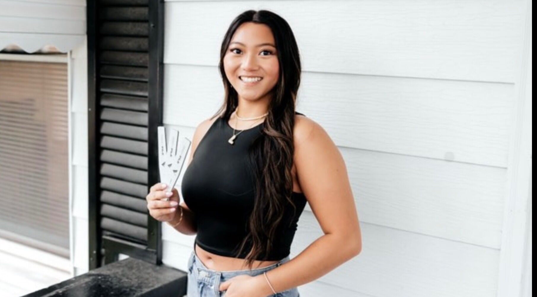 Smiling woman at Happy Nails Spa, Bolivar, Missouri, displaying stylish nail designs.