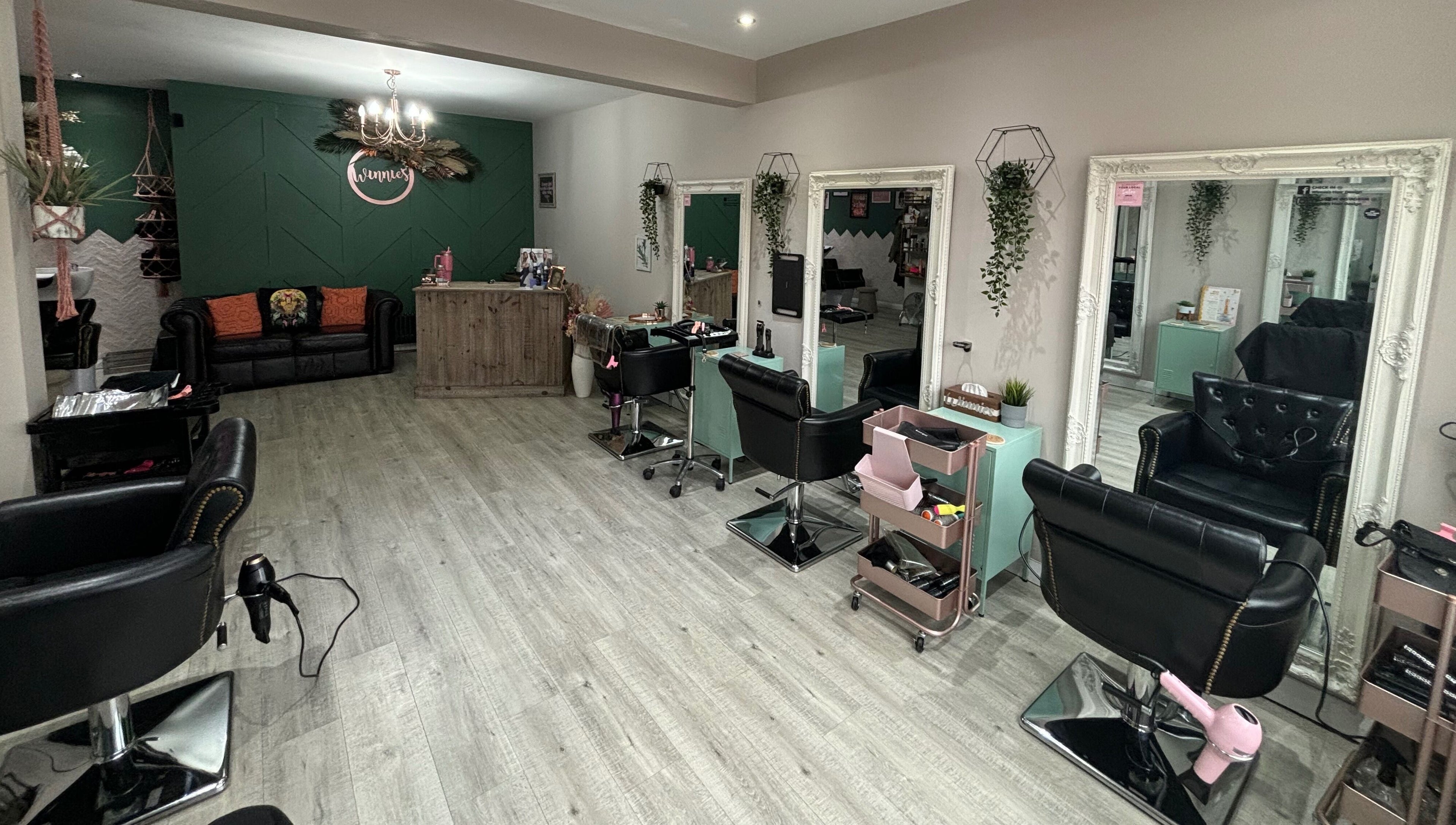 Stylish interior of Winnie's Hair Design in Newcastle upon Tyne, England, GB with modern salon chairs and decor.