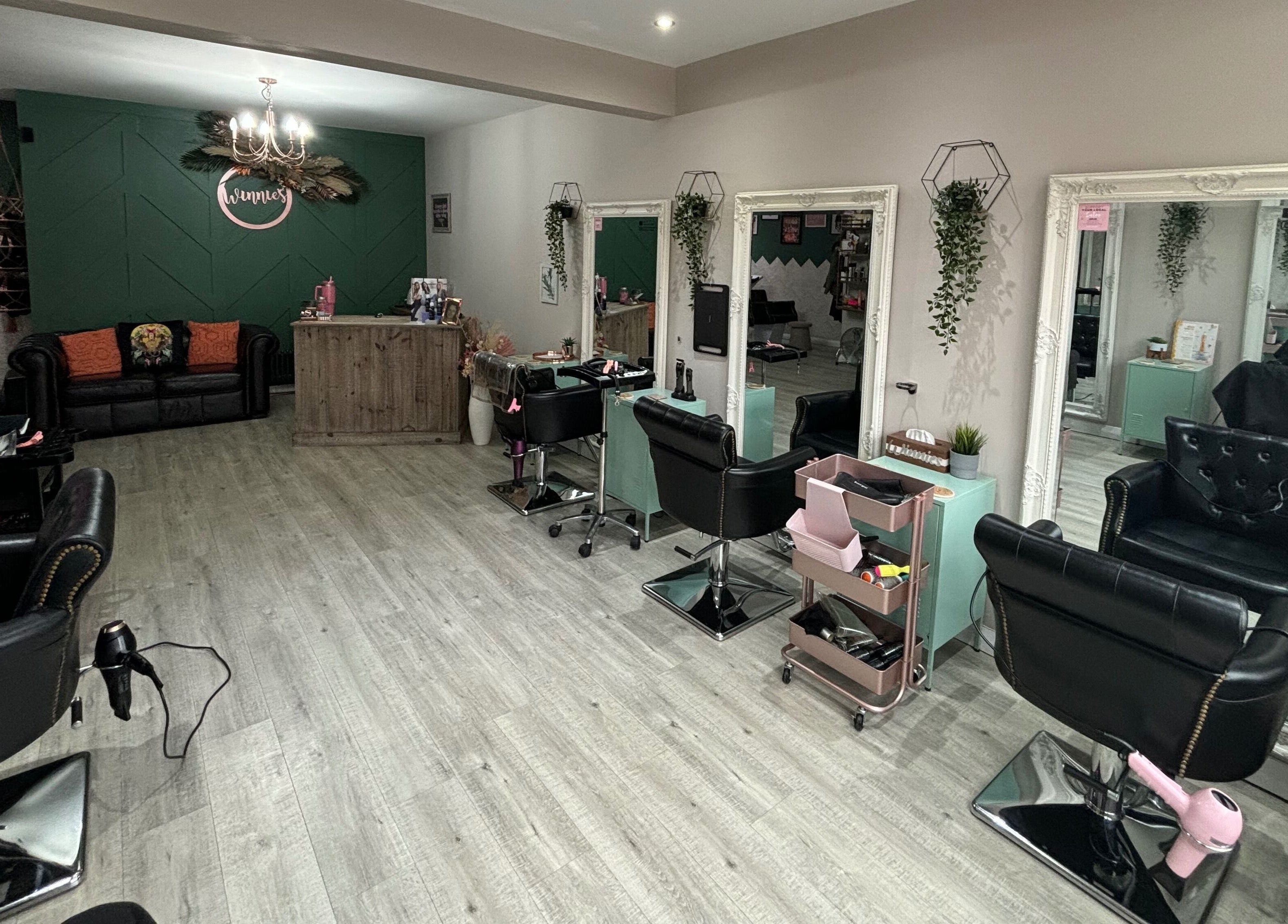 Stylish interior of Winnie's Hair Design in Newcastle upon Tyne, England, GB with modern salon chairs and decor.