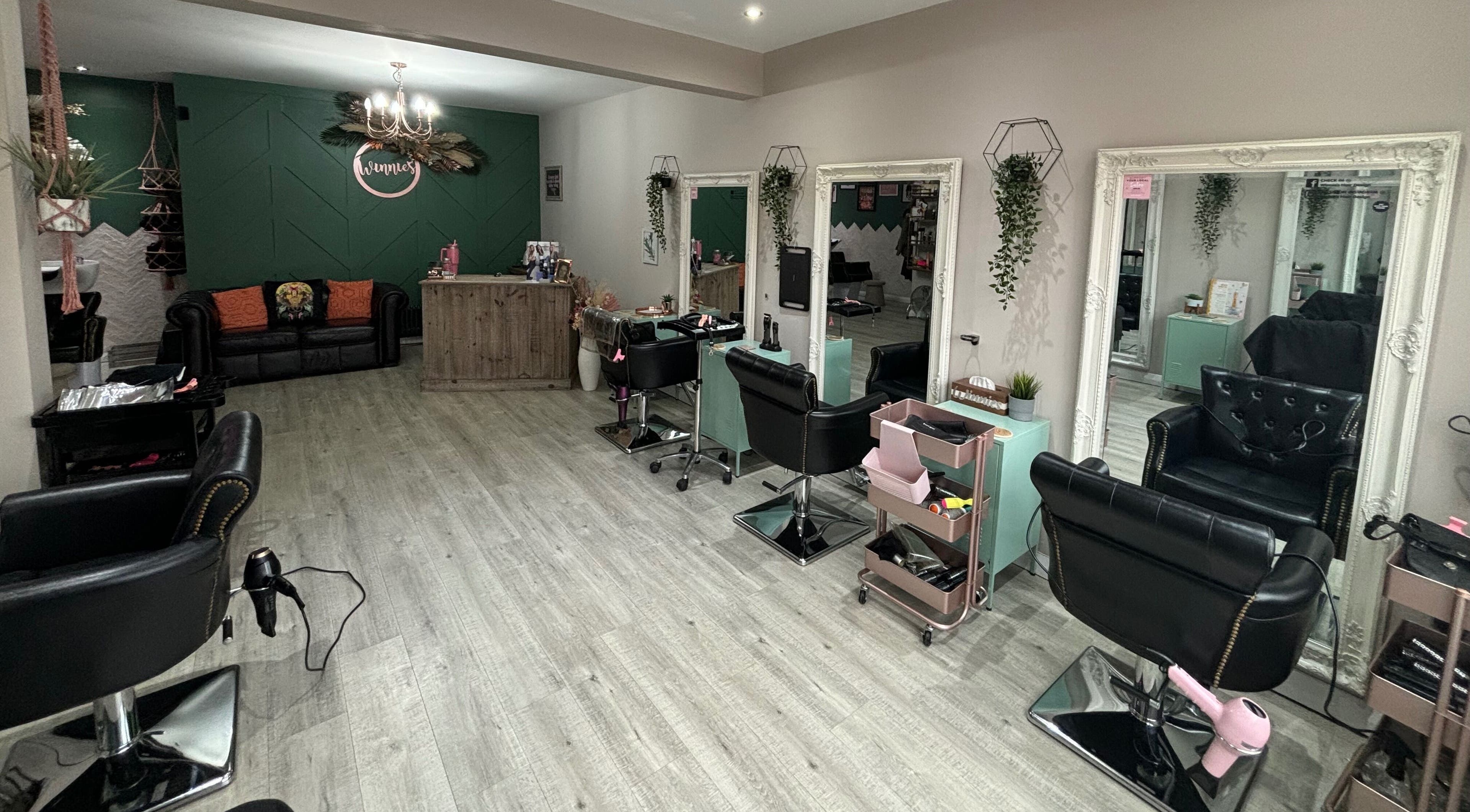 Stylish interior of Winnie's Hair Design in Newcastle upon Tyne, England, GB with modern salon chairs and decor.
