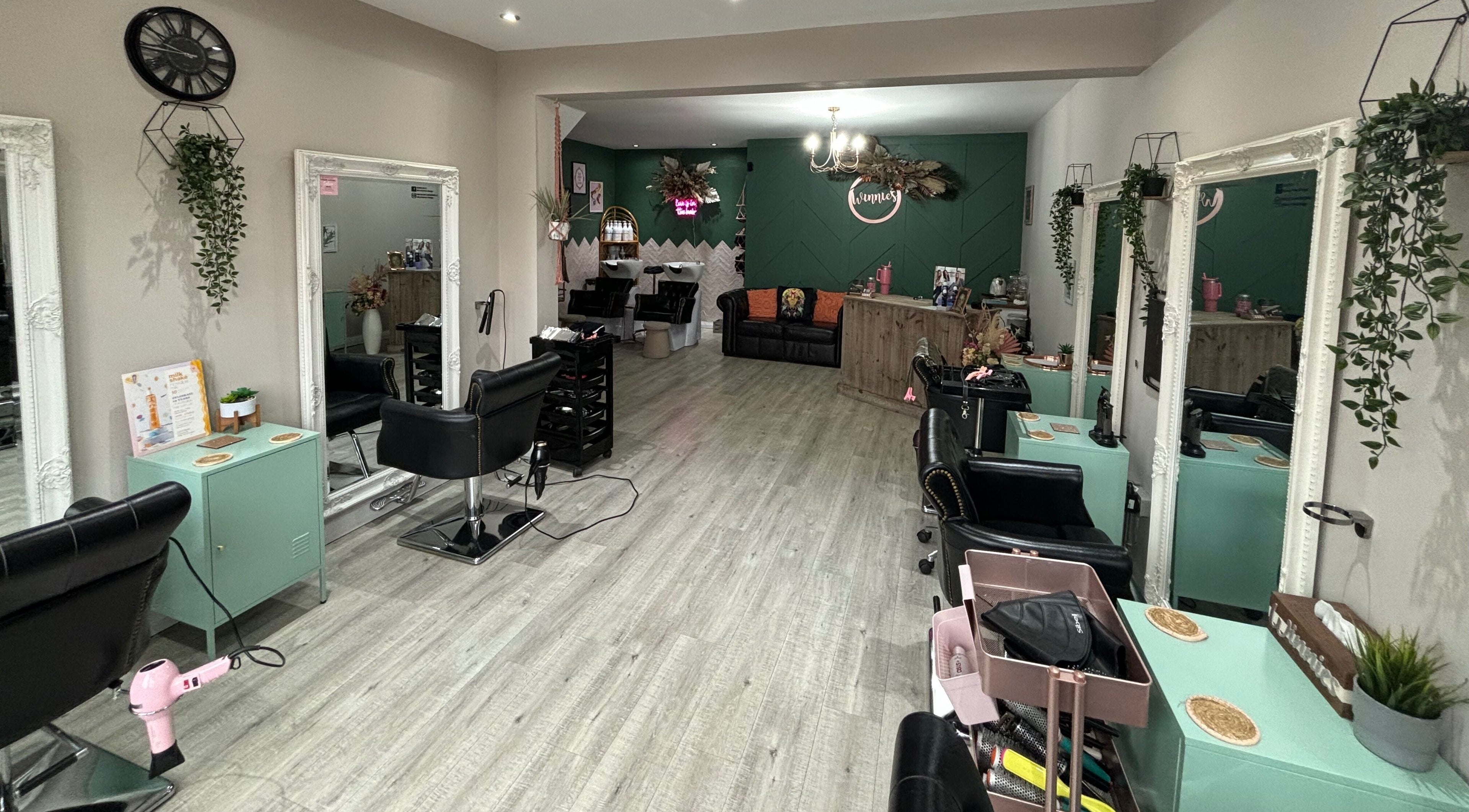 Chic interior of Winnie’s Hair Design in Newcastle upon Tyne, England, GB, showcasing styling stations and decor.