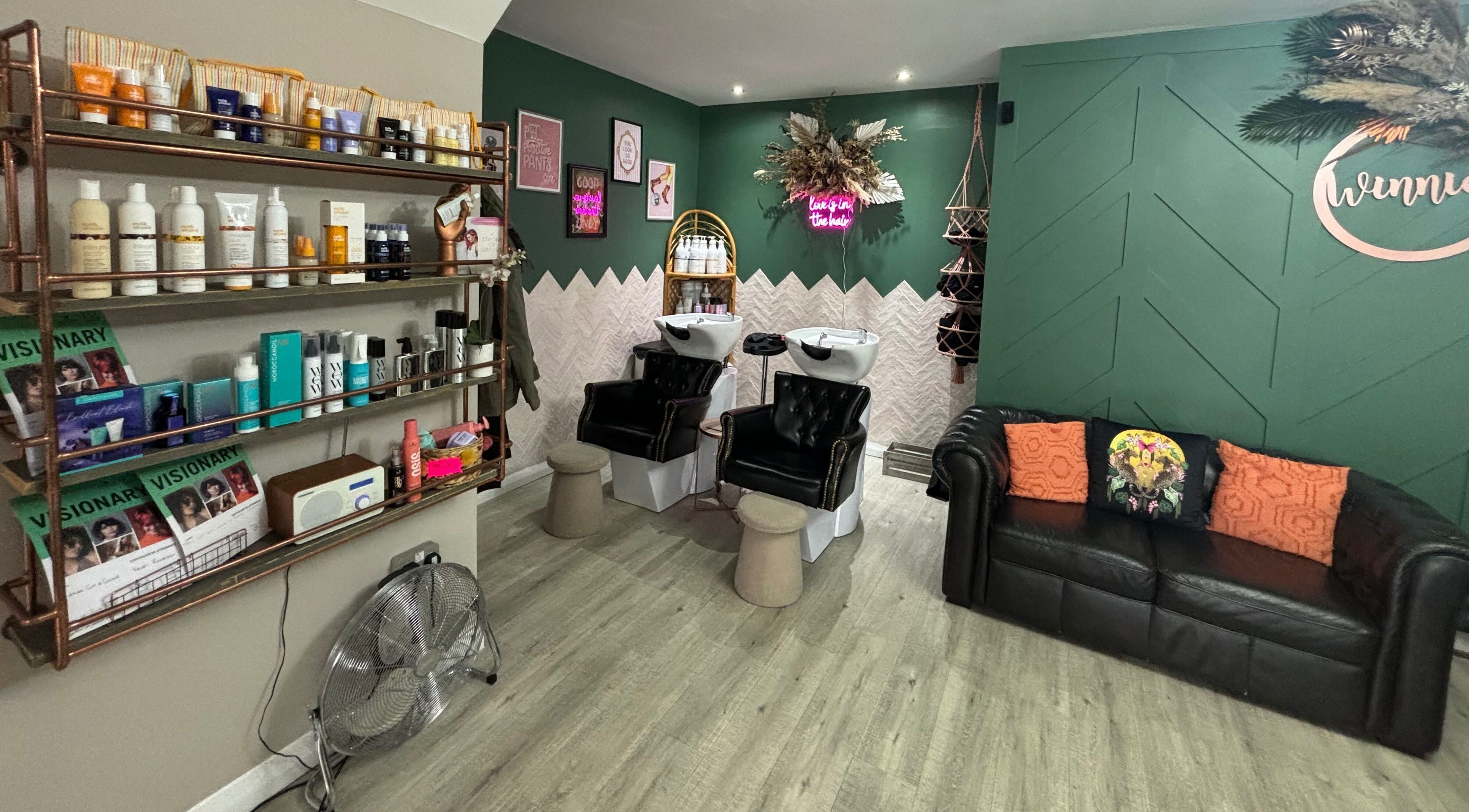 Elegant styling area at Winnie’s Hair Design, Newcastle upon Tyne, England, GB with chic decor and plush seating.