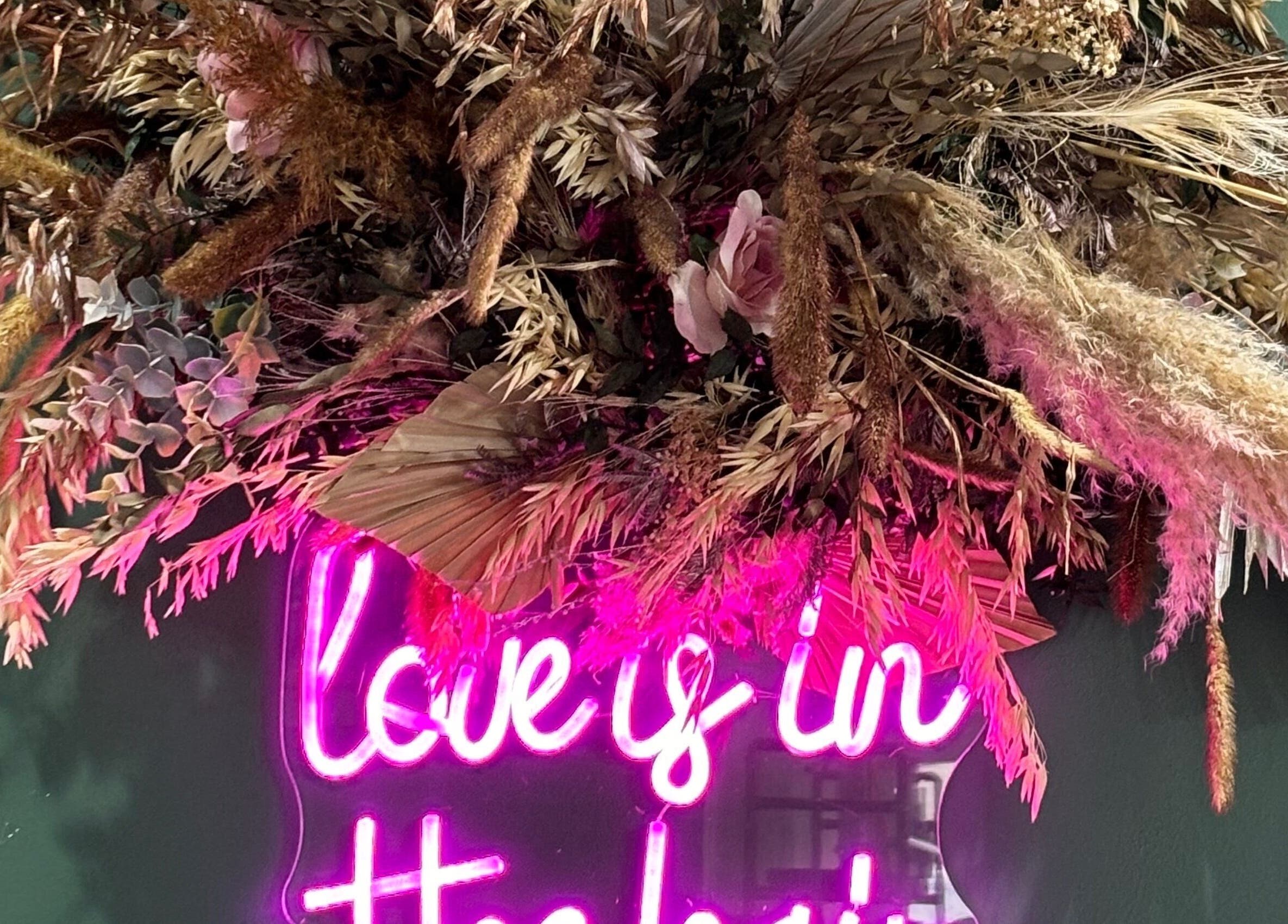 Floral neon sign at Winnie’s Hair Design, Newcastle upon Tyne, England, GB, adding vibrant style and charm.