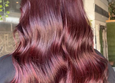 Stunning burgundy waves styled at Hair By David, East Kilbride, Scotland, GB, showcasing vibrant hair color.