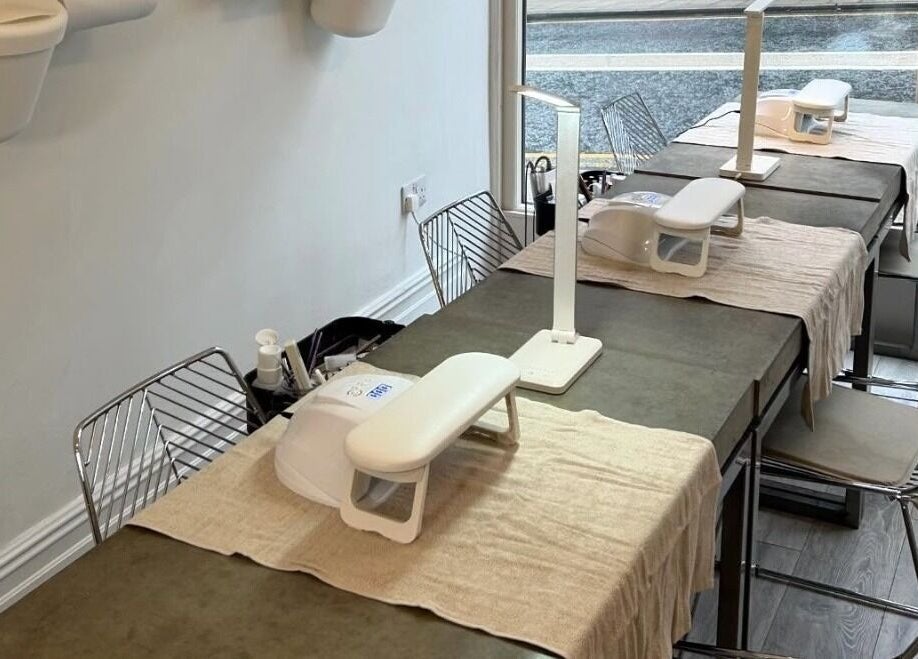 Feathers and Co in Padiham, England, GB showcases modern nail stations with chic decor and ample seating.