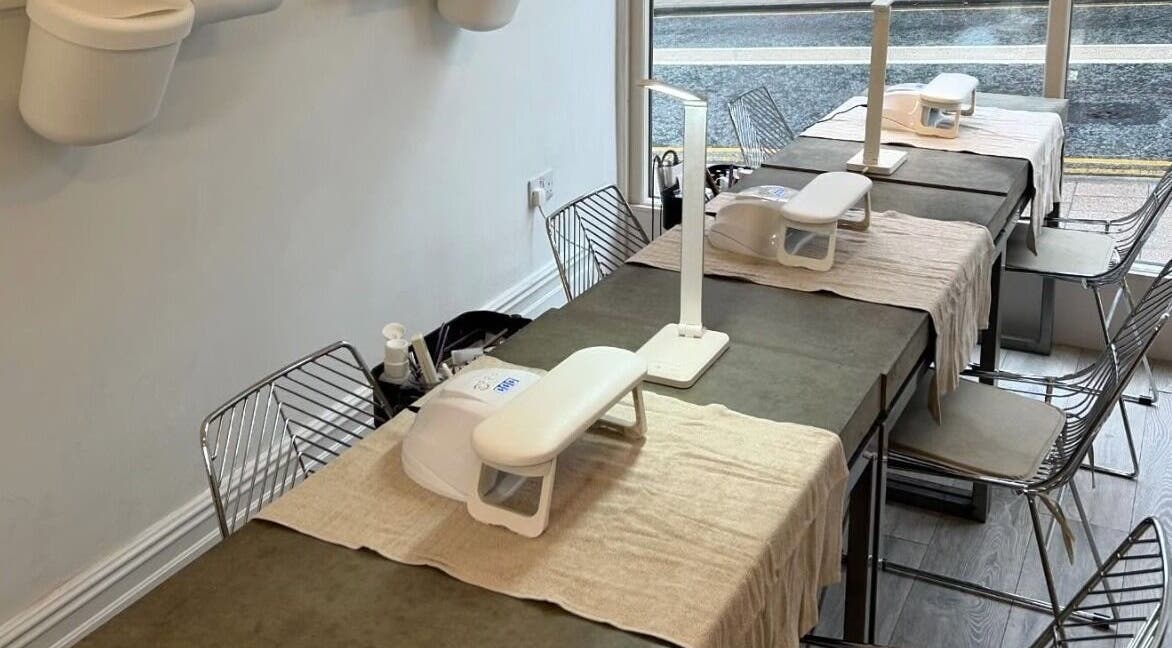 Feathers and Co in Padiham, England, GB showcases modern nail stations with chic decor and ample seating.