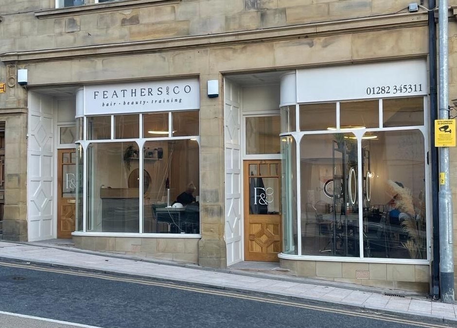 Front view of Feathers and Co at Padiham, England, GB, showcasing elegant glass windows and signage.
