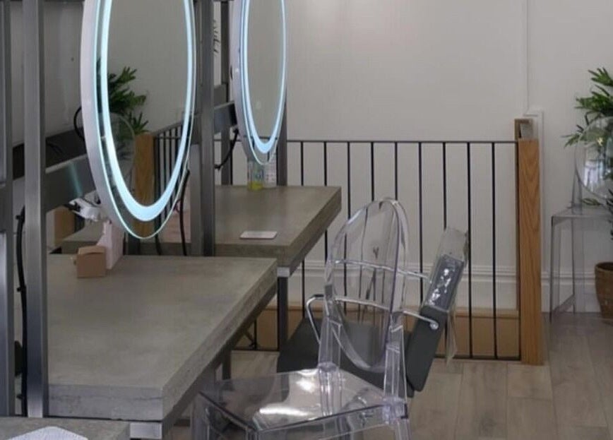 Modern beauty stations at Feathers and Co, Padiham, England, GB, featuring chic mirrors and clear chairs.