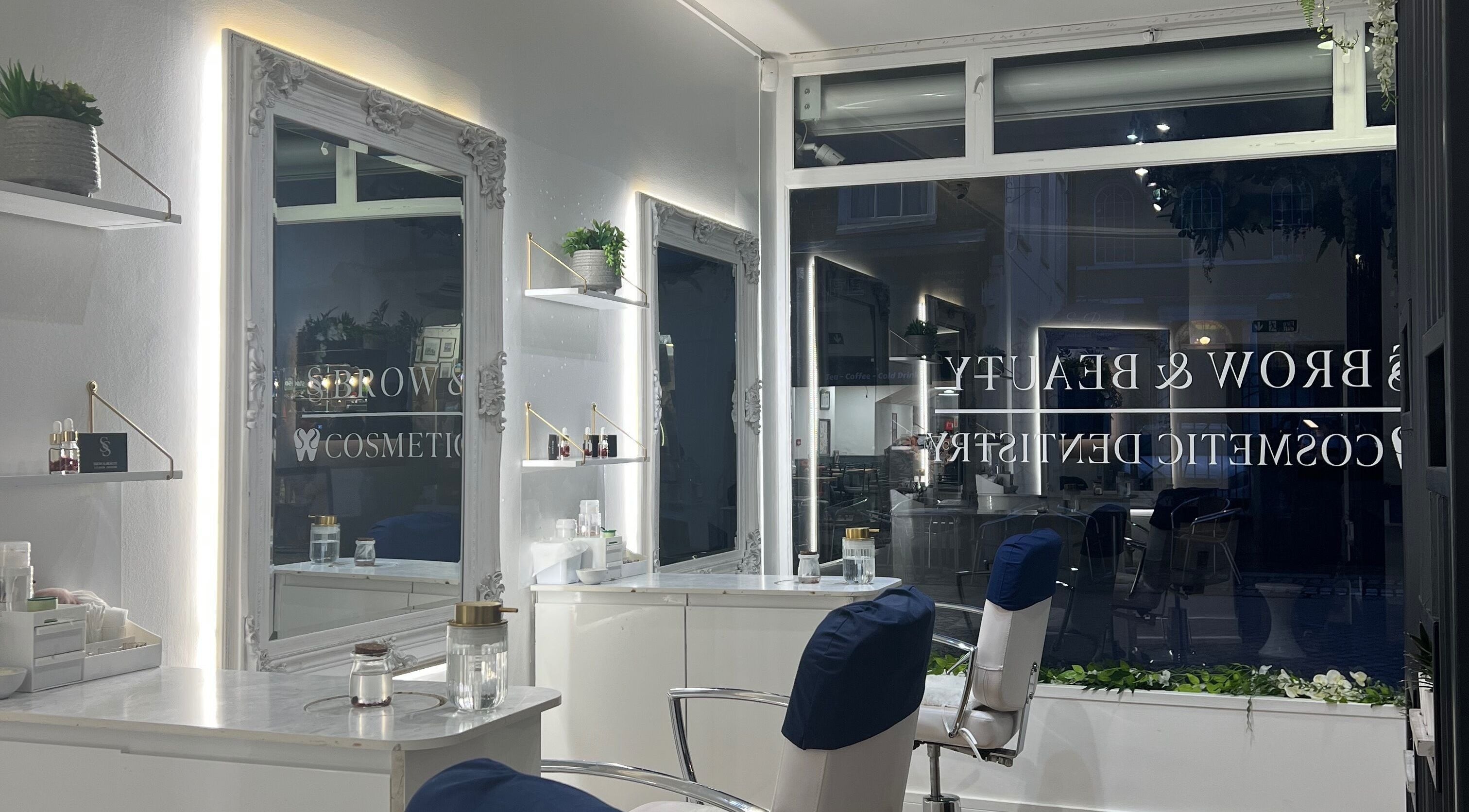 Modern salon interior at SS Brow & Beauty, Canterbury, England, GB, showcasing elegant styling stations.