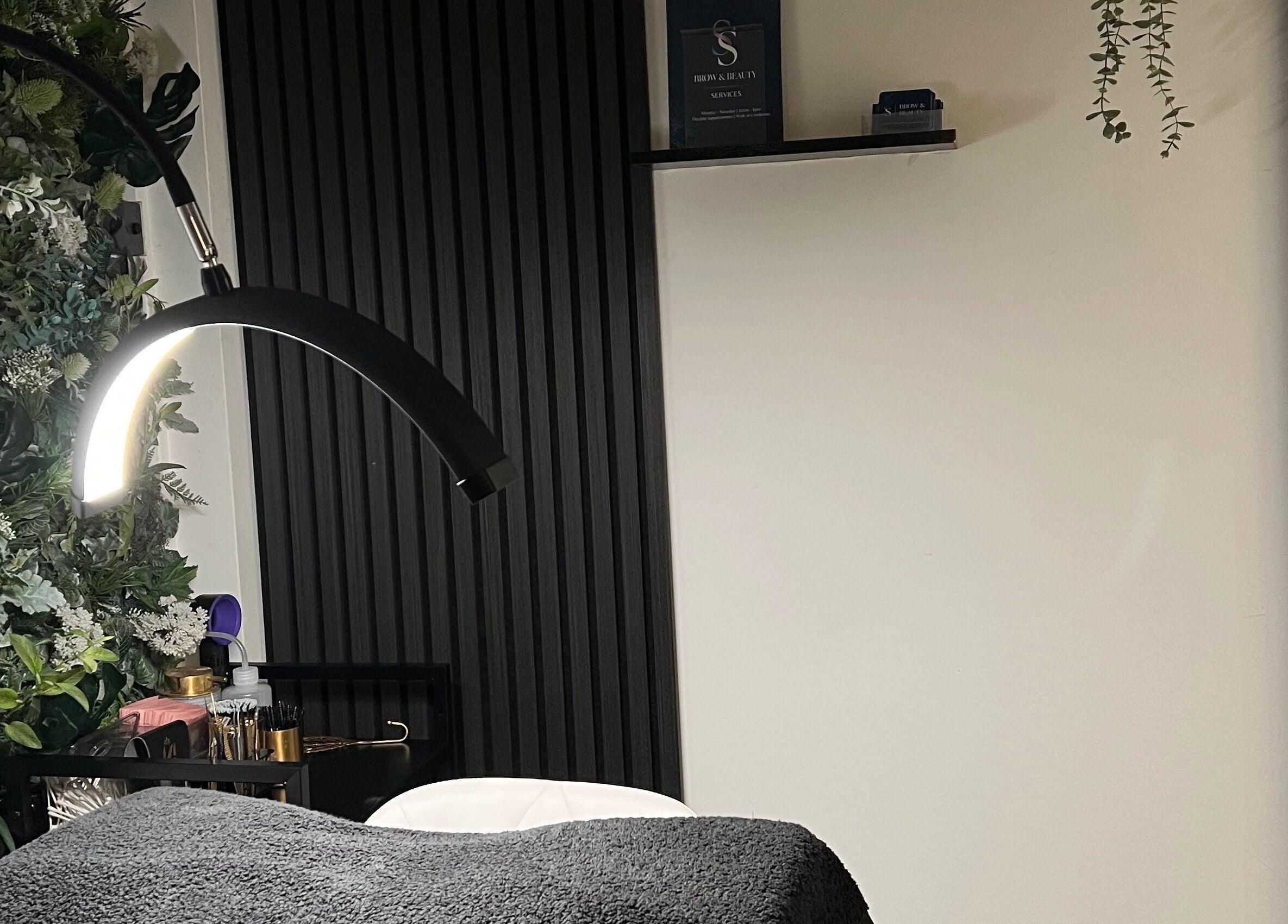 Elegant beauty treatment room at SS Brow & Beauty, Canterbury, England, GB with ambient lighting and lush decor.