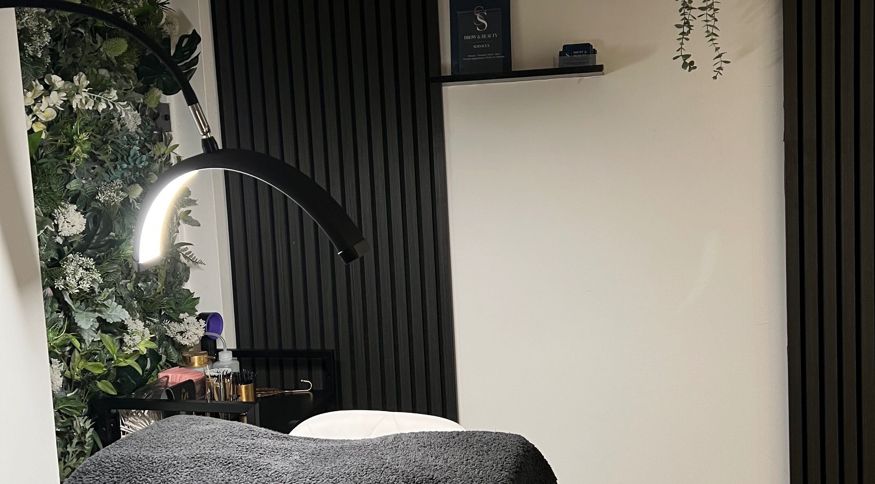 Elegant beauty treatment room at SS Brow & Beauty, Canterbury, England, GB with ambient lighting and lush decor.