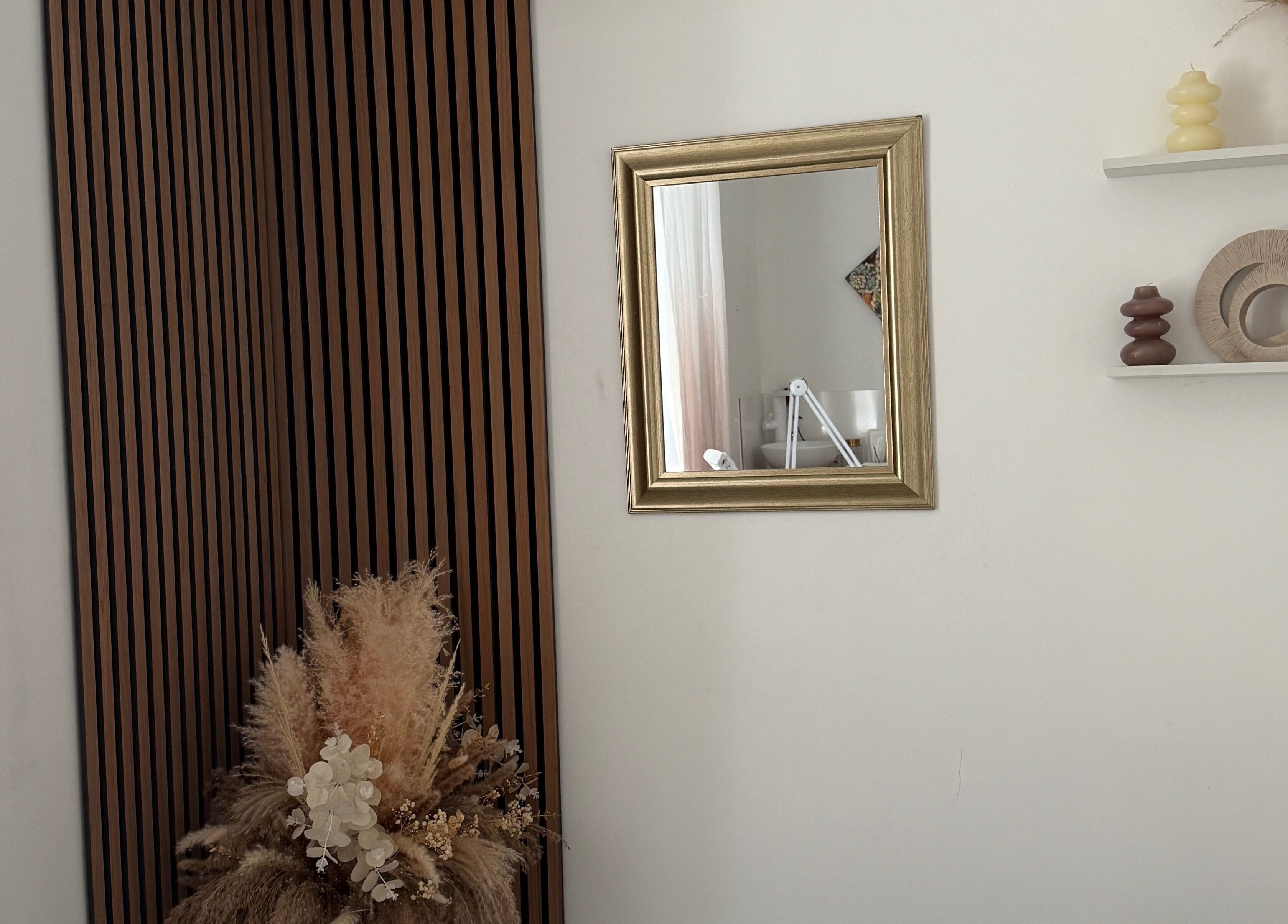 Stylish decor at SS Brow & Beauty, Canterbury, England, GB with a gold-framed mirror and natural accents.