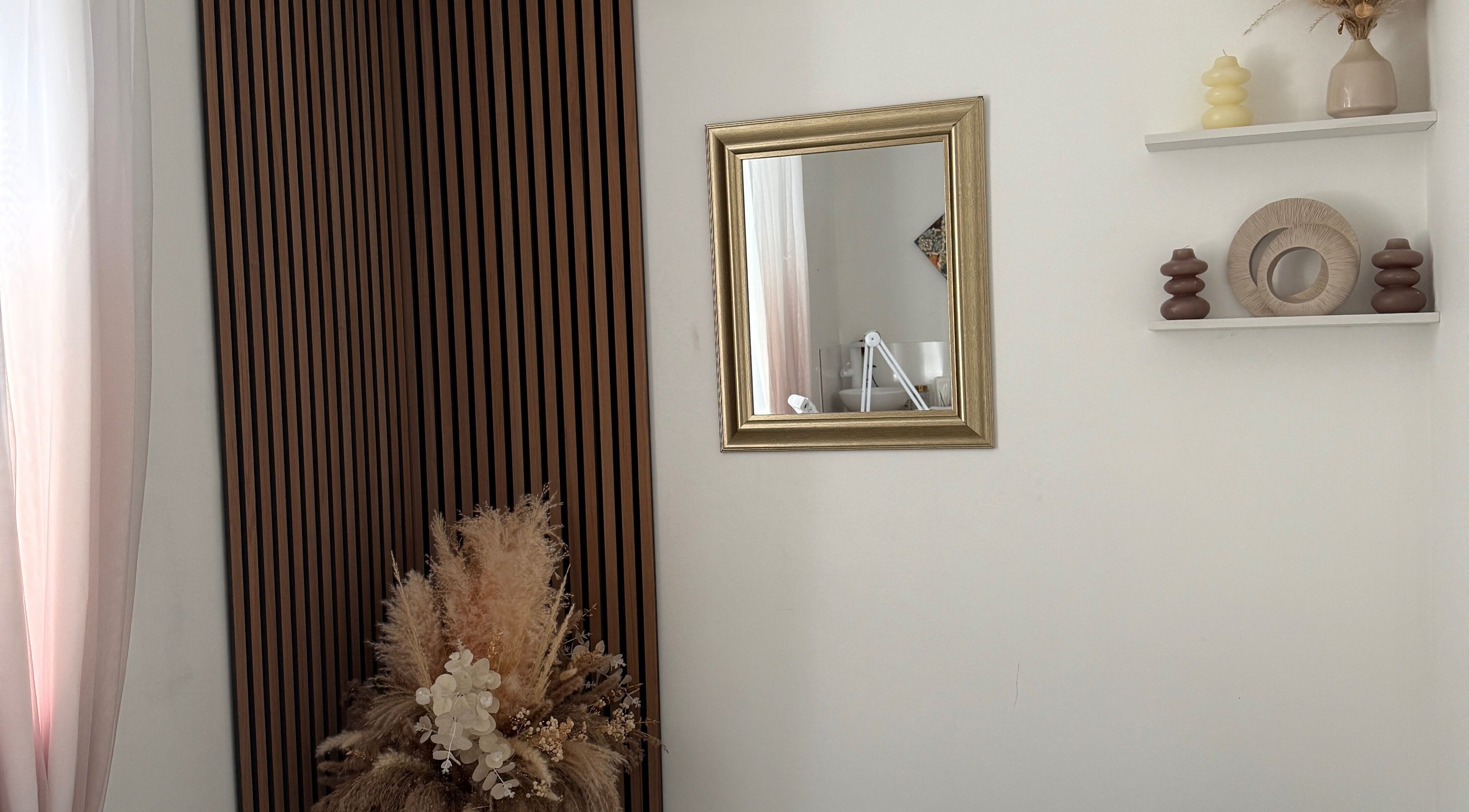Stylish decor at SS Brow & Beauty, Canterbury, England, GB with a gold-framed mirror and natural accents.