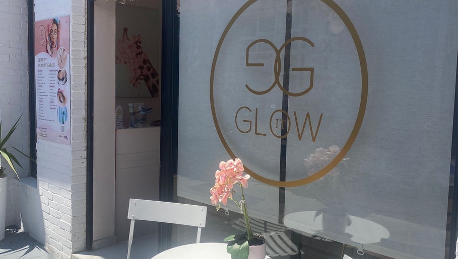 Exterior view of Glow it salon in Limenas Chersonisou, GR showcasing stylish signage and decor.