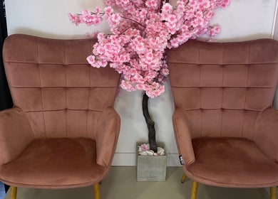 Pink chairs and cherry blossoms at Glow it, Limenas Chersonisou, GR create a serene wellness atmosphere.