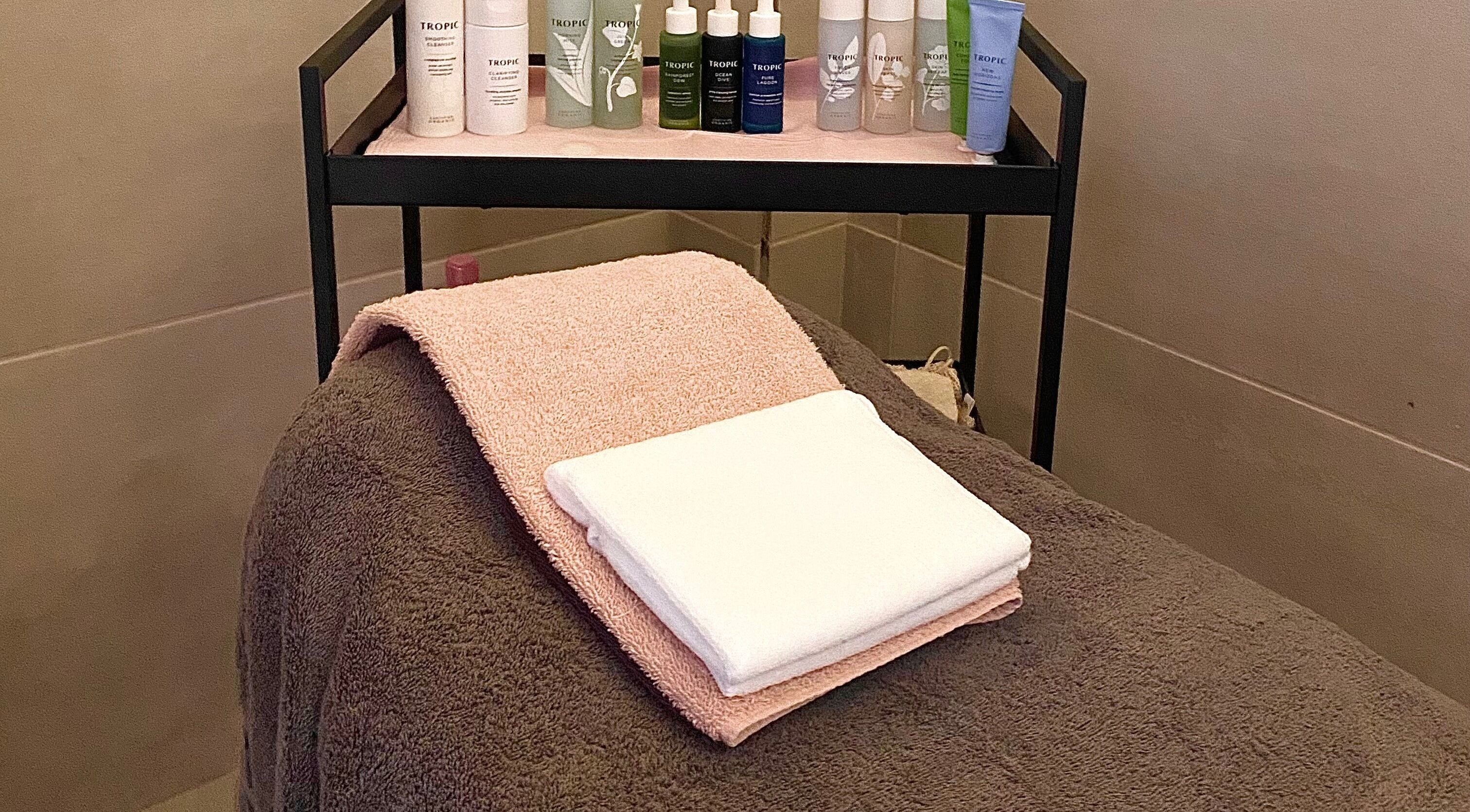 Relaxing spa table with towels and skincare at Glow it, Limenas Chersonisou, GR.