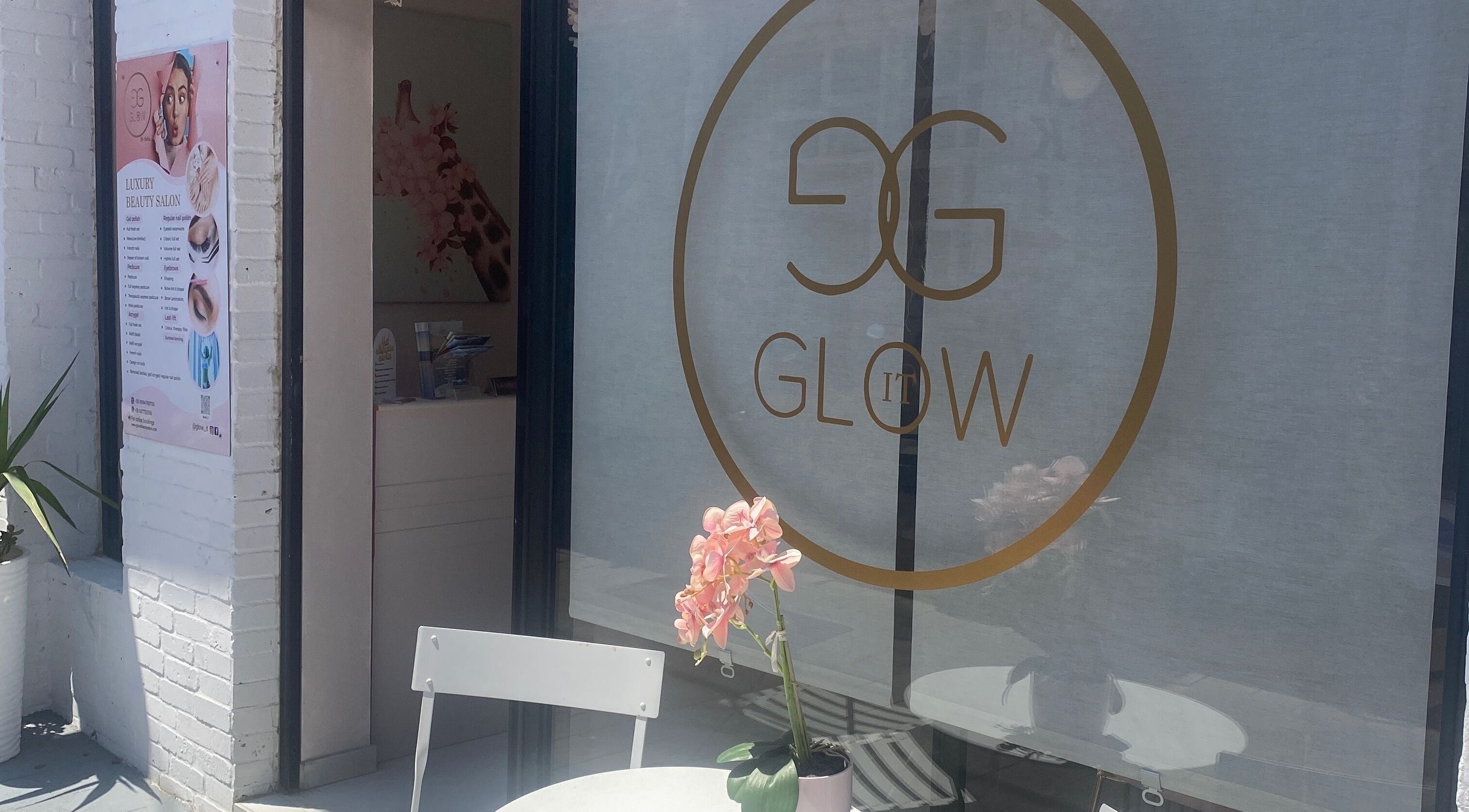 Elegant entrance of Glow it in Limenas Chersonisou, GR featuring a stylish sign and inviting decor.